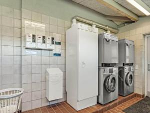 a laundry room with two refrigerators and a washer and dryer at 4 person holiday home in Hampen in Hampen
