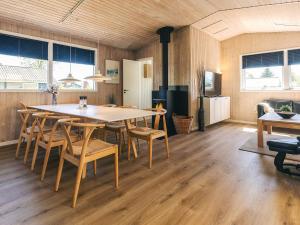 a kitchen and dining room with a table and chairs at 8 person holiday home in Otterup in Otterup +29 photos