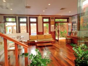 a living room with a couch and some plants at Maison Saiko Angkor Boutique in Siem Reap