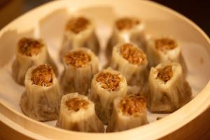a white bowl filled with food with nuts on it at 西安明城墙永兴坊桔子水晶酒店 in Xi'an