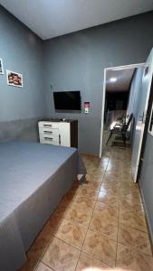 a bedroom with a bed and a flat screen tv at Hotel e Restaurante Santa Isabel in São Raimundo Nonato