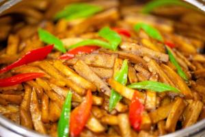 a close up of a bowl of food with vegetables at 西安明城墙永兴坊桔子水晶酒店 in Xi'an