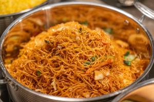 a pot filled with noodles and vegetables in at 西安明城墙永兴坊桔子水晶酒店 in Xi'an