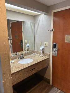 a bathroom with a sink and a mirror at Blue Star Inn in Spartanburg
