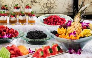 a table topped with bowls of fruit and desserts at Crowne Plaza Orlando-Downtown by IHG in Orlando