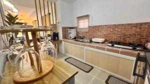 a large kitchen with a counter and a counter top at Hidden Leaf Villa in Caoayan