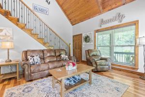 a living room with a couch and a table at Updated Cabin - Hiwassee Highlife in Decatur +56 photos