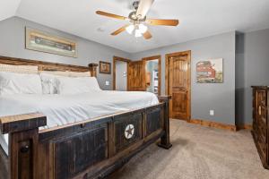 a bedroom with a wooden bed with a ceiling fan at Updated Cabin - Hiwassee Highlife in Decatur