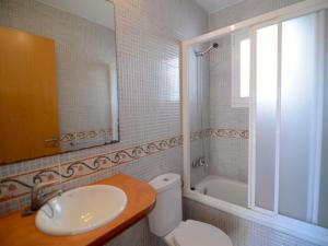 a bathroom with a toilet and a sink and a tub at Spacious duplex Apartment in Estartit in L'Estartit +10 photos