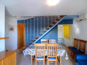 a dining room with a table and a staircase at Spacious duplex Apartment in Estartit in L'Estartit
