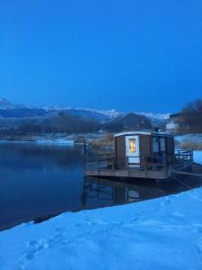 a tiny house on a dock on a lake at У Назгули in Cholpon-Ata