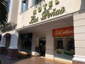 a store front of a building with a sign on it at Hotel Las Peñas in Guayaquil