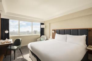 a hotel room with a large bed and a window at Hilton London Metropole in London