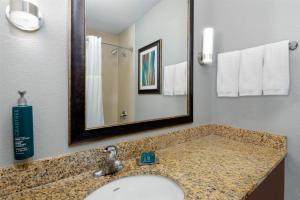 a bathroom with a sink and a mirror at DoubleTree by Hilton Hotel West Palm Beach Airport in West Palm Beach