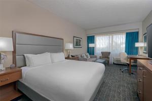 a large white bed in a hotel room at DoubleTree by Hilton Hotel West Palm Beach Airport in West Palm Beach