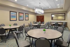 a conference room with tables and chairs and a podium at DoubleTree by Hilton Hotel West Palm Beach Airport in West Palm Beach