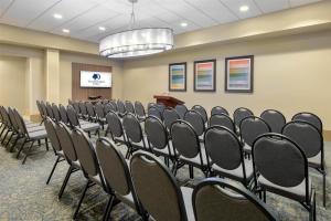 a conference room with rows of chairs and a podium at DoubleTree by Hilton Hotel West Palm Beach Airport in West Palm Beach
