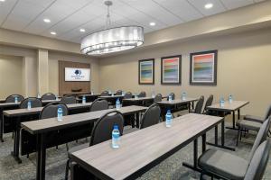 a conference room with tables and chairs with water bottles on them at DoubleTree by Hilton Hotel West Palm Beach Airport in West Palm Beach