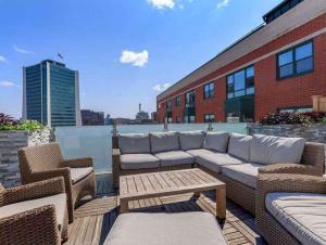 a patio with a couch and chairs on a building at The Monroe Elegant 2BR2BA Downtown Stamford in Stamford