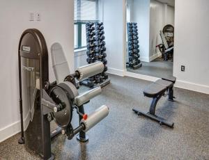 a gym with two treadmills and dumbbells at The Monroe Elegant 2BR2BA Downtown Stamford in Stamford