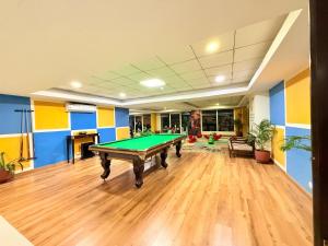 a large room with a pool table in it at Aloha Serenity Apartments in Rishīkesh