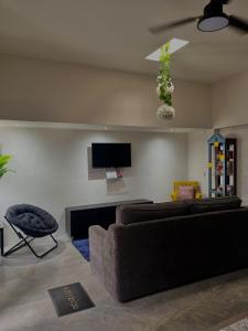 a living room with two couches and a flat screen tv at Casa Josefina Allende Nuevo Leon in Allende
