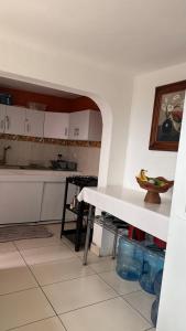 a kitchen with a white table in a room at Casa Porfirio in Oaxaca City