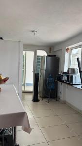 a kitchen with a refrigerator and a counter top at Casa Porfirio in Oaxaca City