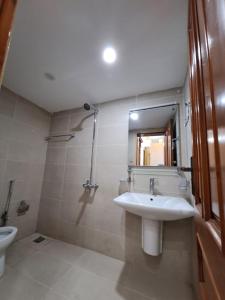 a bathroom with a sink and a toilet at The Guest House Islamabad G-13 in Islamabad +5 photos