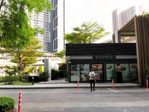 a man standing in front of a store at The Base - Rama 9 by Sumaq Property in Bangkok +1 photo