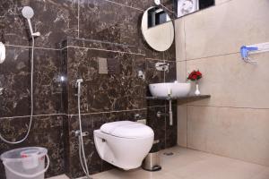 un baño con inodoro y lavabo en Tokio Junglee Backpackers, en Sawāi Mādhopur 4 fotos más