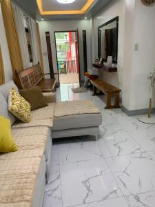 a living room with a couch and a table at PMPJ Staycation in Lipa