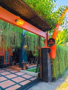 a building with a red roof with plants at Villa Jogja Tropical in Yogyakarta