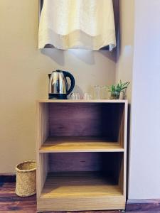 a wooden shelf with a tea kettle on it at Yogi's Heritage in Patan-Beautiful Balcony Room in Pātan