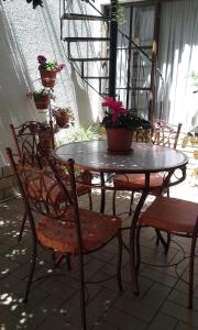 a table and chairs with potted plants on a patio at Casa de Huespedes Isabella in Sucre