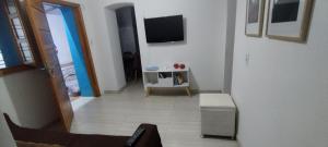a view of a living room with a tv on the wall at Casa Azul em Santa Tereza in Belo Horizonte
