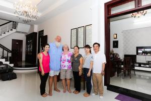 a family posing for a picture in a house at Phoenix Homestay in Hoi An