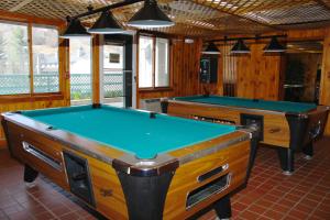 a pool room with two pool tables and lights at Village of Loon Mountain - VI in Lincoln