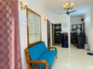 a blue couch sitting in a living room at Good stay TNagar in Chennai