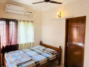 a bedroom with a bed and a ceiling fan at Good stay TNagar in Chennai +4 photos