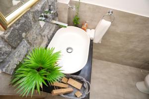 a bathroom with a white sink and a green plant at The Feel Luxury Boutique Hotel Ella in Ella +25 photos
