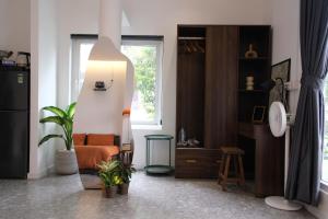 a living room with a chair and a window at Reasonstay Saigon in Ho Chi Minh City