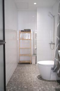 a white bathroom with a toilet and a sink at Reasonstay Saigon in Ho Chi Minh City +26 photos