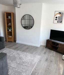 a living room with a mirror and a couch at Beautiful holiday home South Beach Blyth 3 minute walk to the beach in Newsham