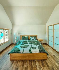 a bedroom with a large bed in a room at Tara Vela in Chumphon