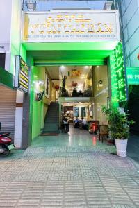 an entrance to a building with a green and white sign at Vuon Tao Dan Hotel - Trung Tâm Thành Phố Gần Chợ Bến Thành in Ho Chi Minh City