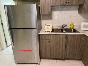 a kitchen with a refrigerator and a sink at Newton Suite in Surrey