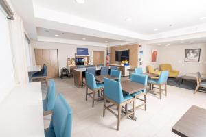 a waiting room with blue chairs and tables at Holiday Inn Express Frackville Hotel By IHG in Frackville