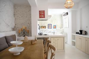 a kitchen with a wooden table and a dining room at Terramare Villa's 3 in Kithnos +26 photos