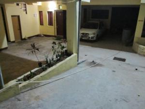 a car parked in a garage with a hose at Merry Villas in Kurseong
